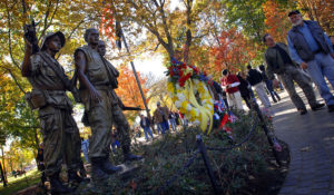 Visitors walk past the Three Servicemen statue at the Vietnam Veterans Memorial in Washington, D.C. Nov. 11, 2010. Hundreds gathered for the annual Veterans Day observance at the National Mall. (United States Department of Defense)