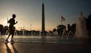 A guy runs through the National World War II Memorial, June 20, 2014 in Washington D.C. The World War II Memorial honors the 16 million who served in the armed forces of the U.S., the more than 400,000 who died, and all who supported the war effort from home. (U.S. Air Force photo by Senior Airman James Richardson)