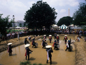 A group of participants from Hiroshima province, Japan, demonstrate rice planting and the hanadave ritual at the 1986 Festival of American Folklife on the National Mall. (Jeff Tinsley/Smithsonian)