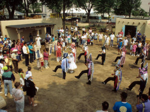 Matachines dance in an adobe plaza constructed for the New Mexico program at the 1992 Festival of American Folklife. (Jeff Tinsley/Smithsonian)
