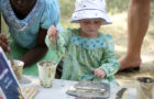 A young attendee learns about Malian art at the 2011 Smithsonian Folklife Festival. (Peace Corps)