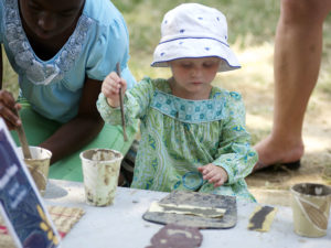 A young attendee learns about Malian art at the 2011 Smithsonian Folklife Festival. (Peace Corps)