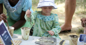 A young attendee learns about Malian art at the 2011 Smithsonian Folklife Festival. (Peace Corps)