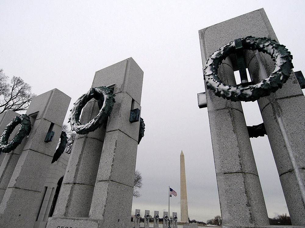 The Washington Monument is framed between pillars adorned with oak and wheat bronze wreaths at the National World War II Memorial located on the National Mall in Washington, D.C. (U.S. Navy photo by Photographer’s Mate 2nd Class Daniel J. McLain)