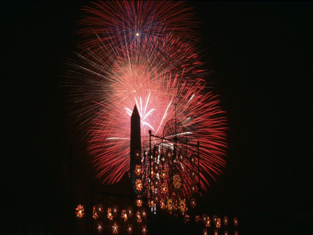 July 4th fireworks highlight the Washington Monument and the Smithsonian Folklife Festival's Philippines Chapel in 1998.