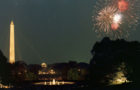 A large audience of White House Staff members watch Fourth of July fireworks from the grounds at the White House.  The Washington Monument and Jefferson Memorial are visible in the background. July 4, 1969.