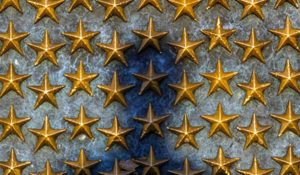 A shadow appears on the wall of stars at the National World War II Memorial, June 20, 2014 in Washington D.C. The World War II Memorial honors the 16 million who served in the armed forces of the U.S., the more than 400,000 who died, and all who supported the war effort from home. (U.S. Air Force photo by Senior Airman James Richardson)