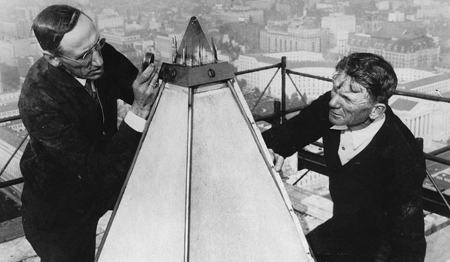 National Bureau of Standards engineer William M. Greig (left) and an unidentified man examine the tip and lighting rods at the top of the Washington Monument in 1934. (Courtesy: Library of Congress)